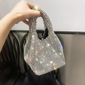 Elegant silver rhinestone bucket handbag with chain strap shown in handheld display - Silver