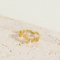 Detailed view of a gold vine ring with pink marquise zircon on a beige stone surface - Pink Marquise Zircon Vine Style