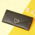 Detail of dark green textured leather long wallet with gold heart buckle and envelope flap - Green
