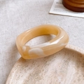 Detail of amber and cream marbled resin square bangle on a decorative stone tray - 12# Bangle-White-Geometric
