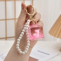 Pink Capybara liquid sand keychain with pearl strap and golden metal ring - Chain Style-Glitter Lying Back