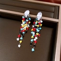 Macro shot of long tassel earrings with multicolored beads and silver needle studs - Silver - Rainbow