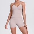 Close-up of seamless halter yoga top and high-waisted shorts set in beige fabric - XS / Porcelain Pink