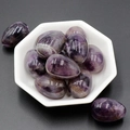 Polished egg-shaped natural amethyst crystals in a white bowl on dark background - Amethyst (1pc)