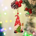 Detail of wooden Christmas gnome ornament with red hat hanging on a festive pine branch - Style 3