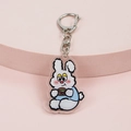 Cute acrylic rabbit keychain eating a burger with silver metal ring on pink stand - Hamburger Rabbit