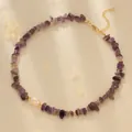 Detail of amethyst gravel necklace with a white pearl on elegant satin fabric - Amethyst Color