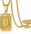 Macro shot of gold box chain necklace featuring a textured letter U pendant - Letter U