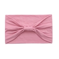 Close-up of pink elastic cotton yoga headband with a decorative twisted knot detail - Lotus Pink