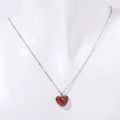 Silver stainless steel necklace with a polished red heart pendant on a white mannequin - Silver Stainless Steel / Red Agate Silver Necklace