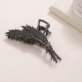Dettaglio dell'elegante pinza per capelli color canna di fucile con strass brillanti - Nero