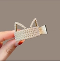 Close-up of golden cat ear hair claw clip with multiple rows of white pearls - Cat Gold Pearl