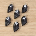 Detail of six black enamel ghost charms with smiley faces on a wooden background - Ghost