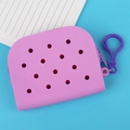 Pink silicone hole bag coin purse with purple hook clasp on bright blue background - Purple
