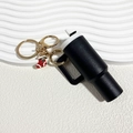 Mini black cup keychain with a red Christmas stocking charm and gold metal ring clasp - Christmas Black