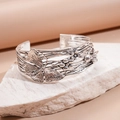 Detailed relief of vintage butterfly and floral patterns on antique silver cuff bracelet - Silver