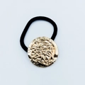 Elegant black elastic hair tie featuring a round vintage textured golden metal disc - Round Embossed Hammered Pattern (Hair Tie 82)