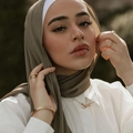 Olive green pearl chiffon hijab scarf shown on model with gold accessories - Army Green