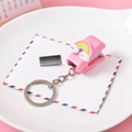 Cute pink mini stapler keychain featuring a rainbow cloud charm and refill staples - Rainbow Baby