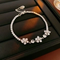 Detailed shot of silver flower bracelet with sparkling cubic zirconia on black leather box - Clear Zirconia / Silver