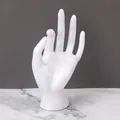 White hand-shaped resin jewelry display stand for showcasing rings and bracelets - White