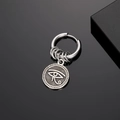 Retro stainless steel hoop earring with Eye of Horus charm on black mirror surface - Eye of Horus