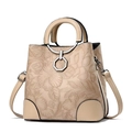 Detail of elegant beige bucket bag with floral embossed pattern and silver hardware - Khaki