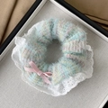 Detail of plush blue and pink scrunchie with delicate lace edges and a sweet pink bow - Bowknot Style / Green