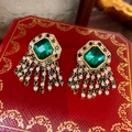 Close-up of vintage emerald crystal tassel earrings on a red luxury gift box - 925 Sterling Silver Pin Tassel Style / Emerald Green (Gold Base)