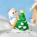 Resin Christmas snowman pushing a tree miniature with dimensions 4.4cm by 4.8cm - No. 4 Snowman with Christmas Tree