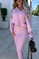 Outdoor street view of a woman wearing a pink V-neck knit sweater and matching midi skirt - Pink