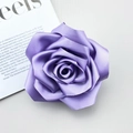 Detailed macro shot of light purple handmade satin rose camellia accessory with silk texture - Purple