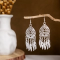 Detailed close-up of bohemian silver tassel earrings with hollow leaf and feather charms - Silver Hollow Feather Tassel Style 2(E2875-16)