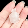 Mini natural translucent white crystal turtle carving held between fingers for scale - White Crystal