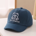 Detailed view of white cartoon bear embroidery and Till SUNRISE text on navy cotton cap - 52cm 2-5 Years Old / Blue