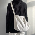 Large capacity white canvas crossbody bag with wide strap shown on a model's back - Slouchy Style / White