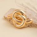Detailed view of the chunky gold knotted metal hair tie on a decorative stone base - Minimalist Knot Hair Clip / Gold