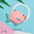 Macro view of ocean style resin fish charm in pink and cyan for DIY crafts - Pink Turbot