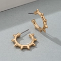 Macro shot of gold punk hoop earring with rivets and spiked metallic textures - Gold Yellow