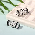 Detail of candy-shaped glass beads with spiral white stripes and black dots for DIY jewelry - Black and White