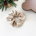 Elegant champagne satin scrunchie with soft pleated texture on a white surface - Medium / Champagne