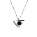Macro detail of a silver geometric triangle pendant necklace with a black stone inlay - Triangle White Gold Color