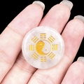 25mm white natural stone pendant with gold Yin Yang Tai Chi symbol on black background - White Crystal