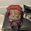 Ethnic bohemian style red bucket bag with colorful tassel charms and wide woven strap - Red