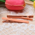 Detail of coral orange 6cm metal duckbill hair clips with matte finish and jagged grip - Orange
