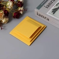 Yellow textured paper envelopes for jewelry packaging displayed with rose and book - 7x7x2cm / Yellow Cardboard Sleeve