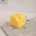 Handmade yellow cheese shaped scented candle in a compact 6.1cm cube design - Square Cheese