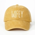 Close-up of mustard yellow washed canvas baseball cap with white WIFEY embroidery - Yellow