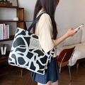Large black and white cow print canvas tote bag with woven shoulder strap - Encounter Bears / White