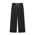 Detail der weiten Hose mit weißem Kordelzug und elastischem Bund in Schwarz - XS / Schwarz